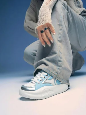 Pastel platform runner sneakers styled with baggy denim and a knitted sweater in a casual Korean streetwear outfit