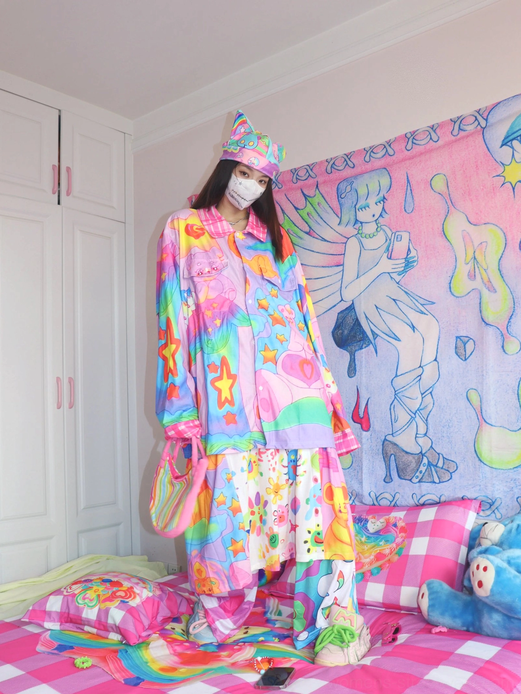 Pastel rainbow cartoon graffiti streetwear shirt styled with a matching crossbody bag in a playful Y2K Harajuku-inspired outfit