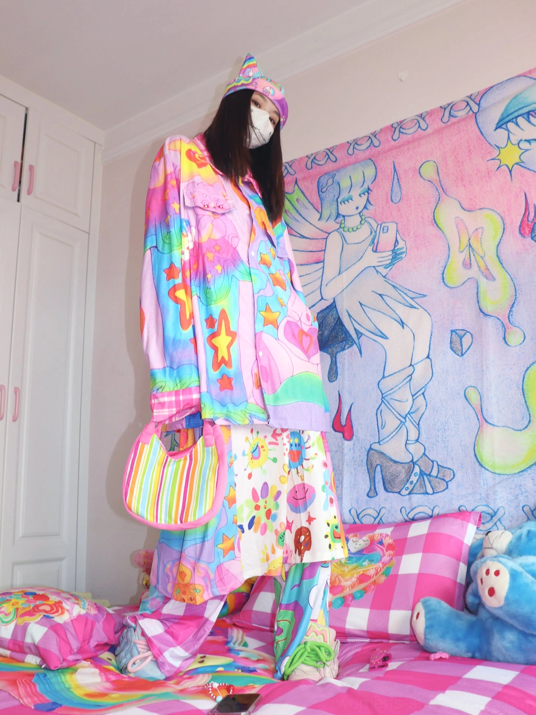 Pastel rainbow graphic streetwear shirt with pink plaid collar and cuffs shown in a relaxed oversized fit with macaron color details