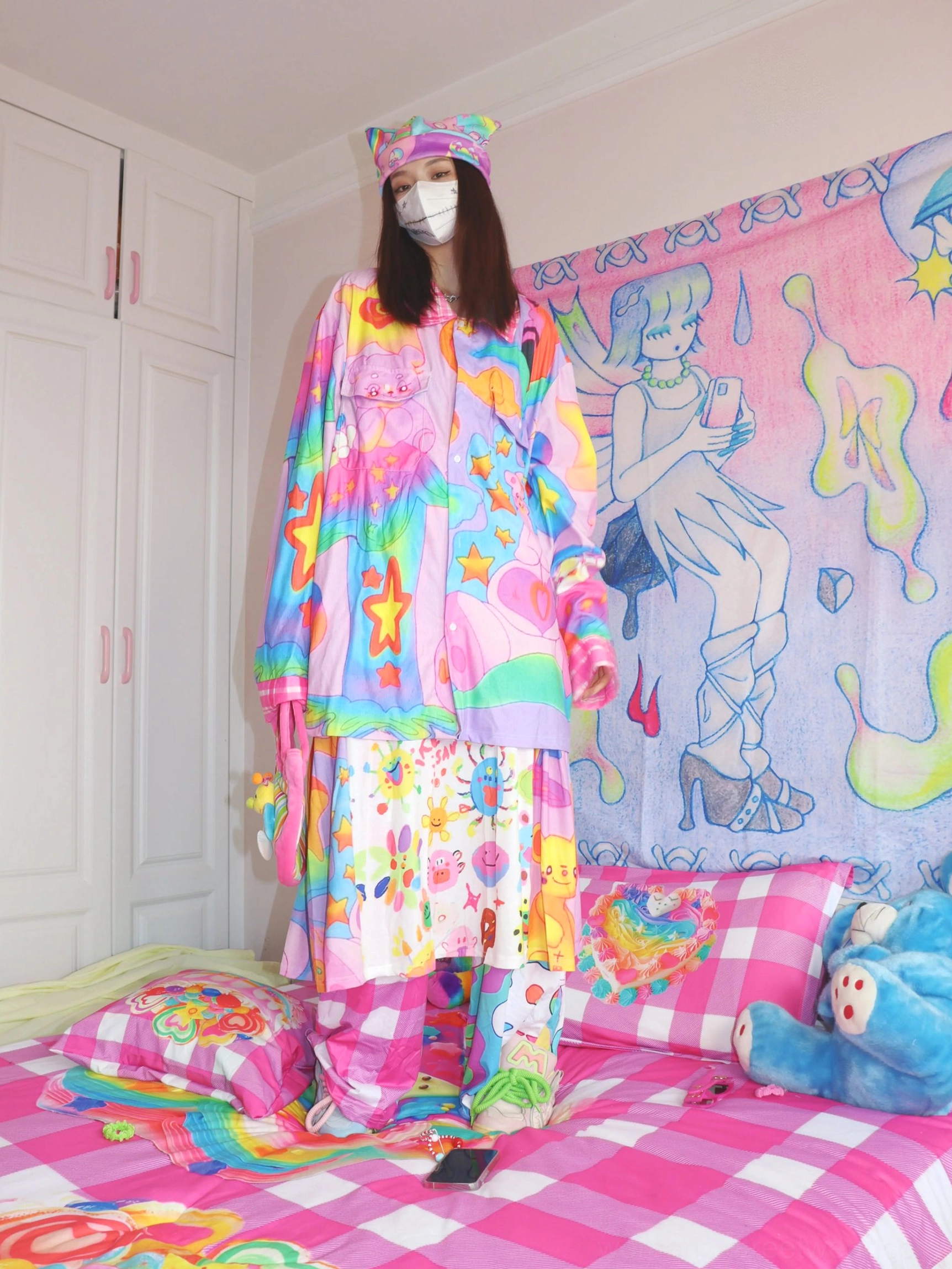 Colorful pastel rainbow star streetwear outfit with cartoon graffiti print styled with a cute cat ear headband and Y2K fashion accessories