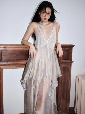 Pastel tie dye chiffon slip dress shown from the front three-quarter view with deep V neckline, spaghetti straps, layered asymmetric ruffle skirt, and flowing maxi silhouette