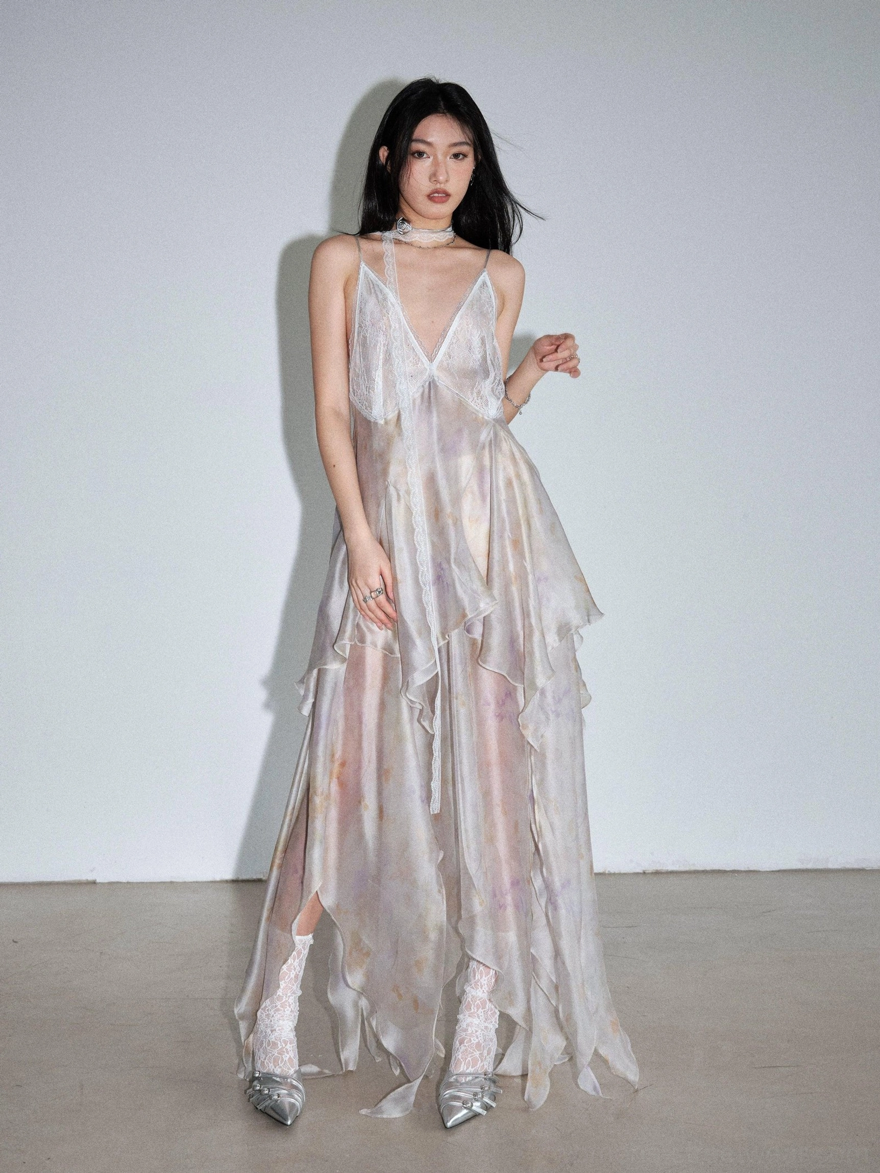 Pastel tie dye chiffon slip dress shown in a full front view with delicate spaghetti straps, layered ruffle skirt, and floor-length maxi cut