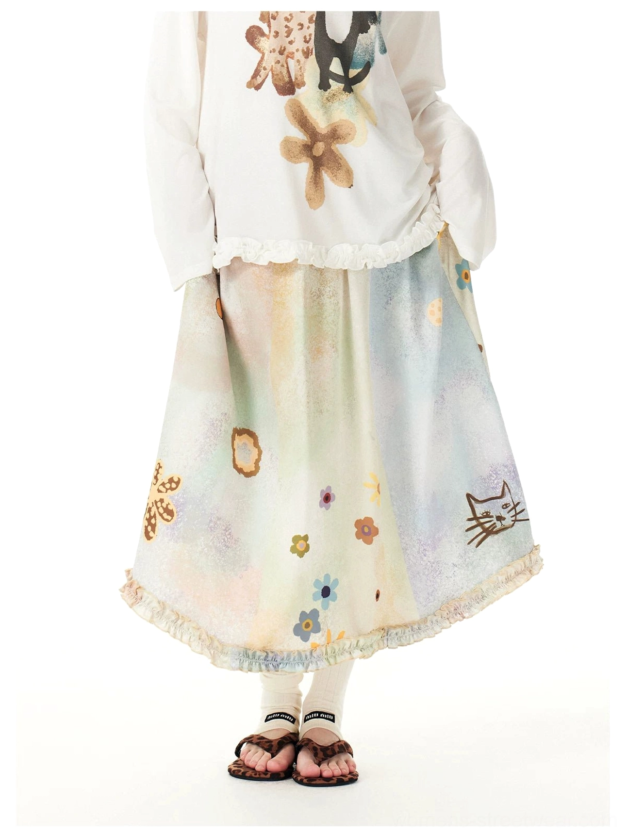 Front view of a pastel watercolor cat and floral maxi skirt with elastic waistband and softly ruffled ankle-length hem