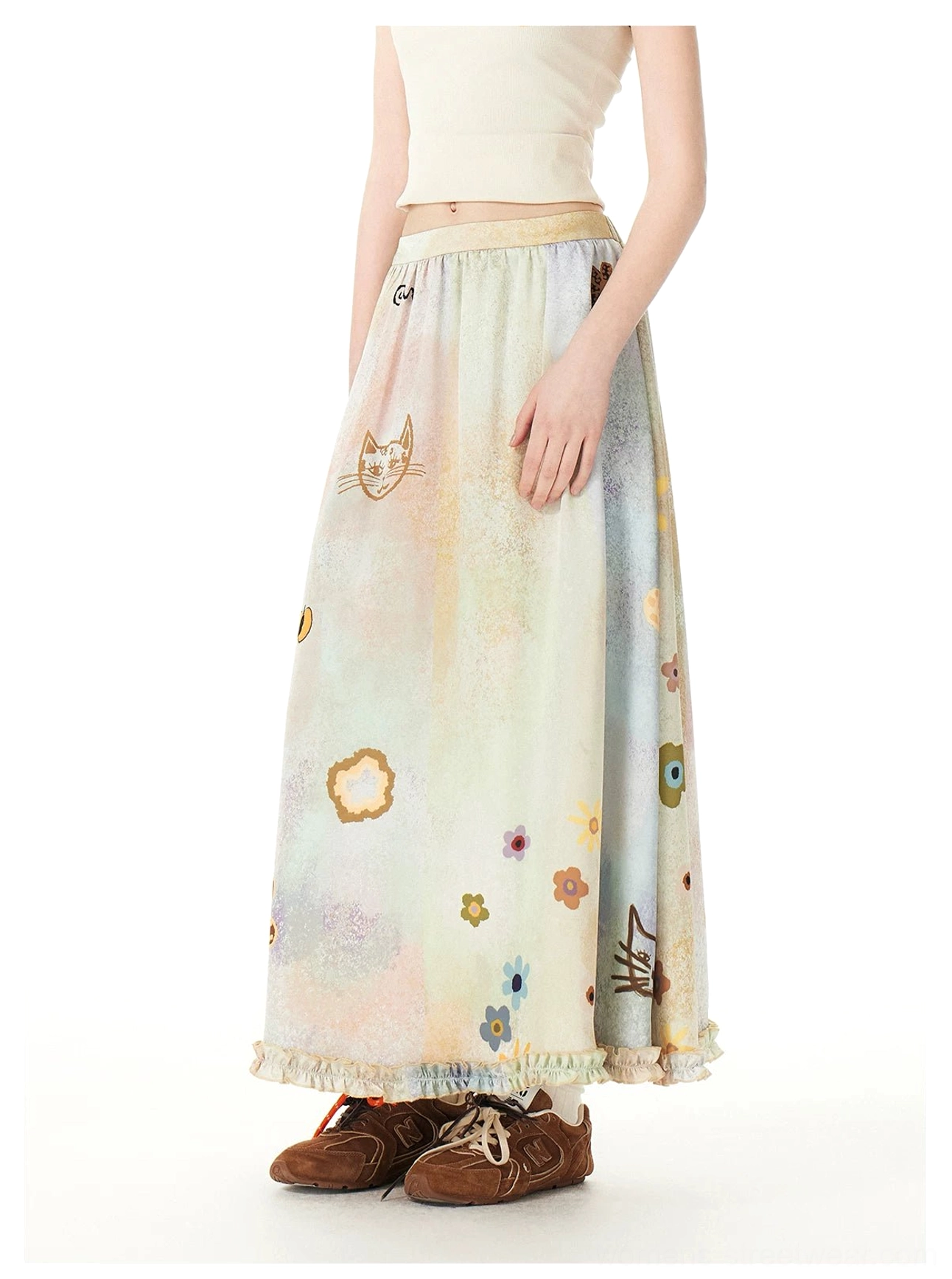 Front lower-body view of a pastel watercolor maxi skirt featuring cute cat prints, floral doodles, elastic high waist, and ruffled hem