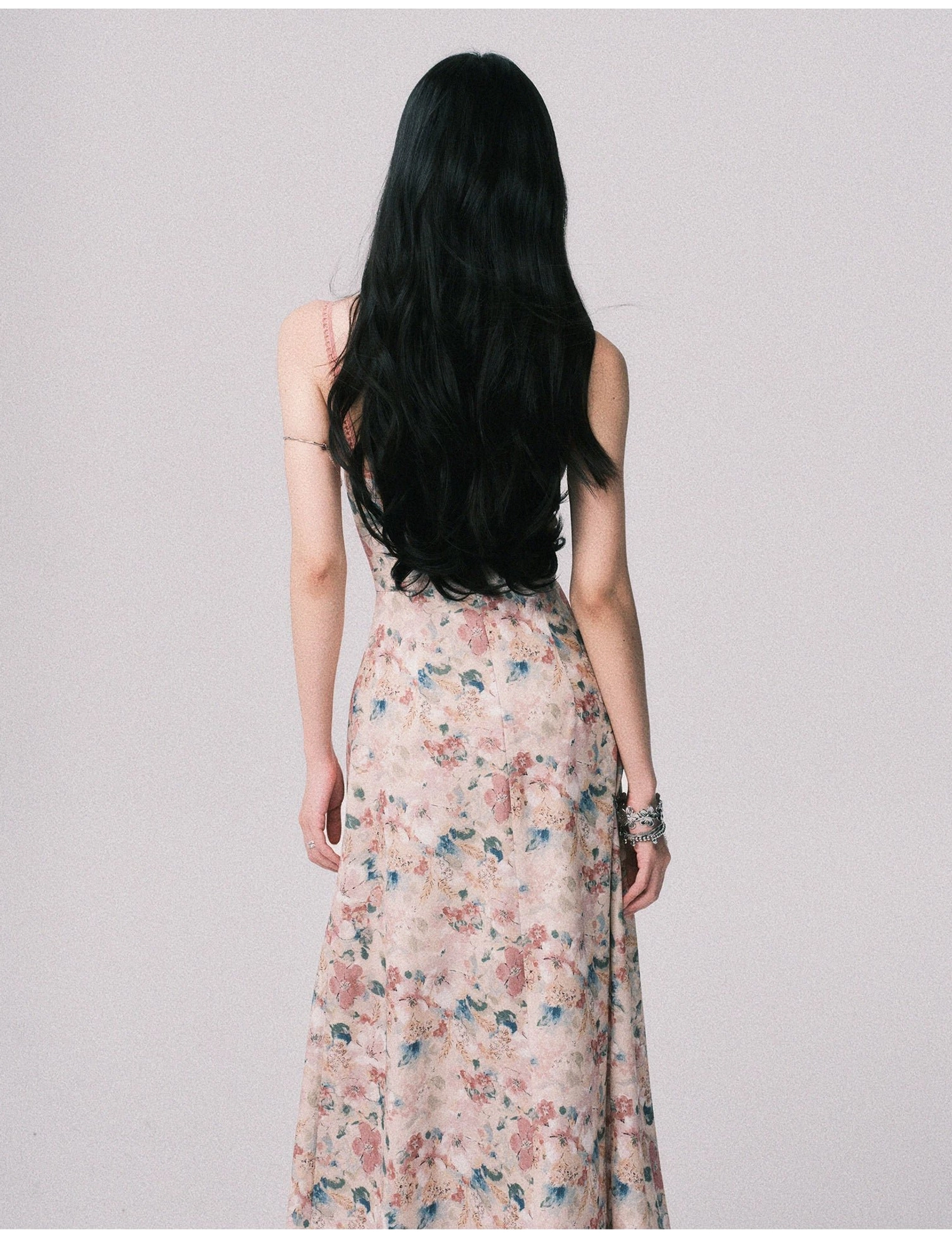Pastel watercolor floral backless cami maxi dress product detail showing the romantic fitted bodice, delicate straps, and flowing printed skirt