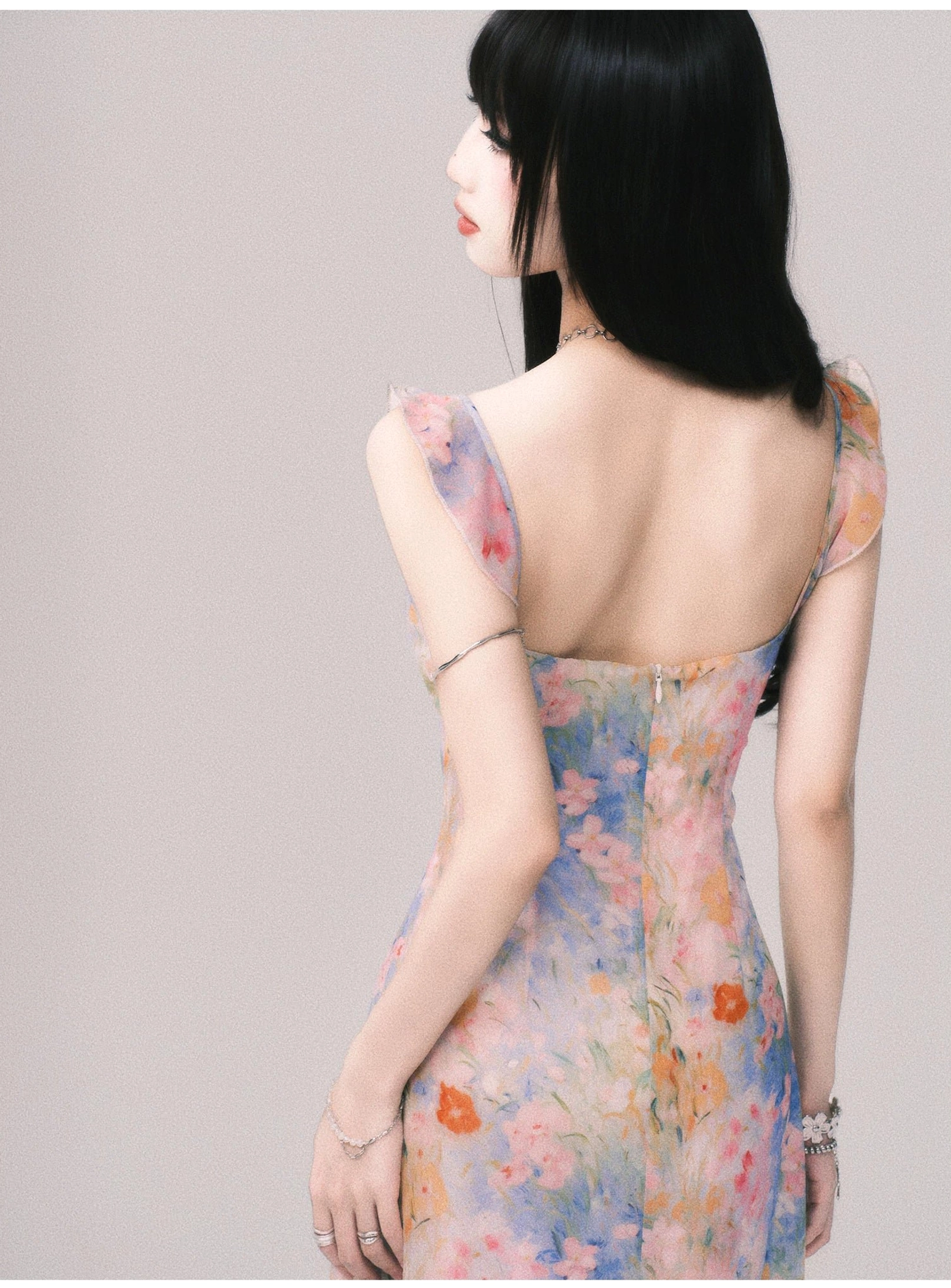 Women's pastel floral maxi slip dress featuring a romantic ruffle neckline and flowing long skirt