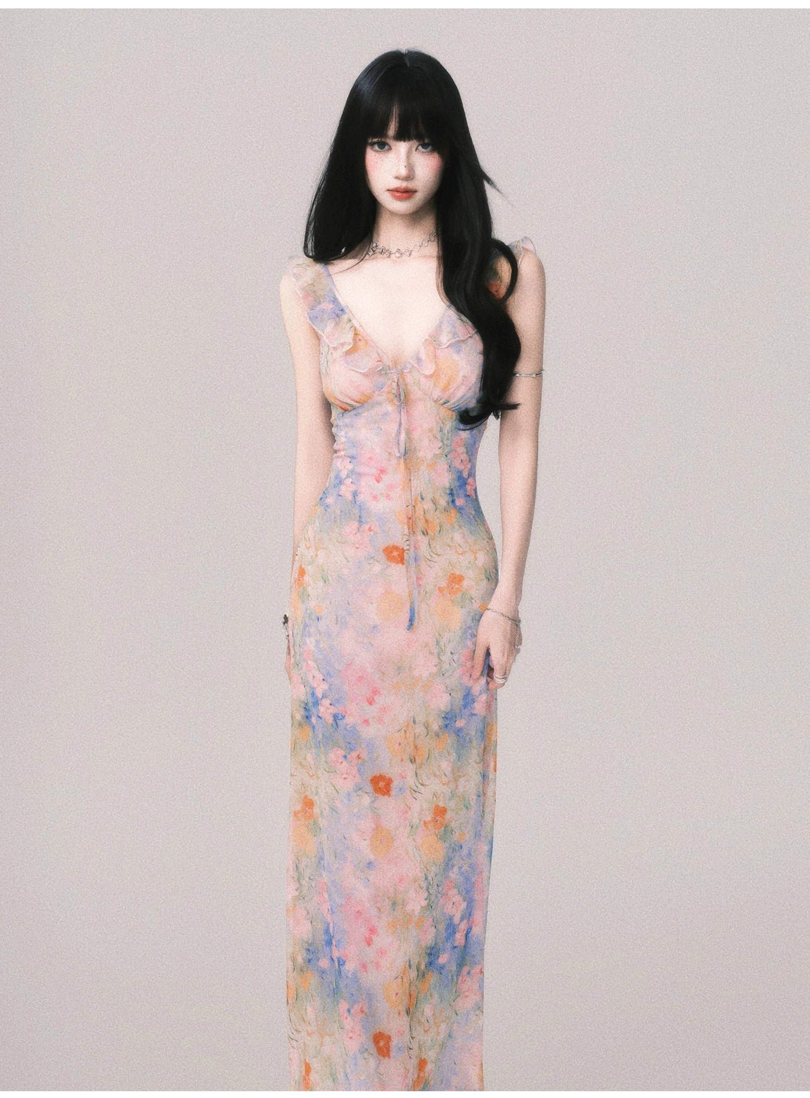 Pastel watercolor flower print maxi dress with slim straps and fitted bodice shown from the front
