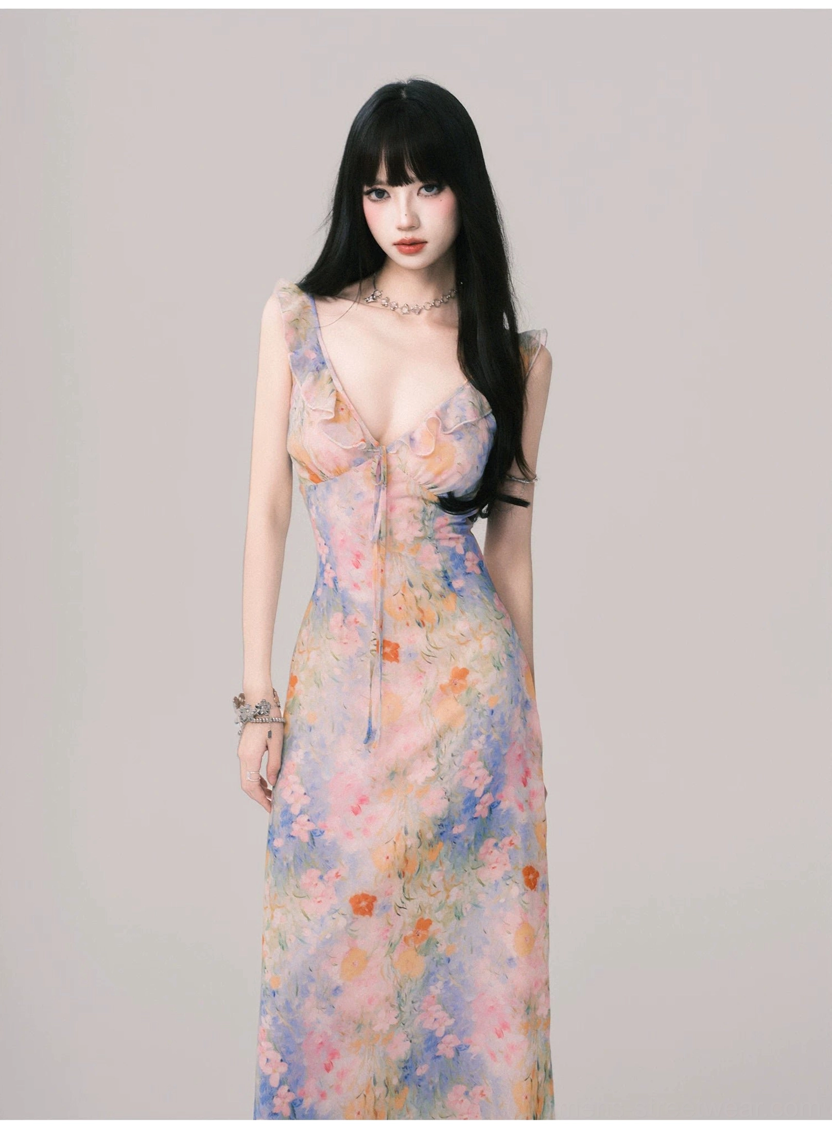Women's pastel floral ruffle maxi slip dress styled with delicate jewelry in a full-length studio portrait