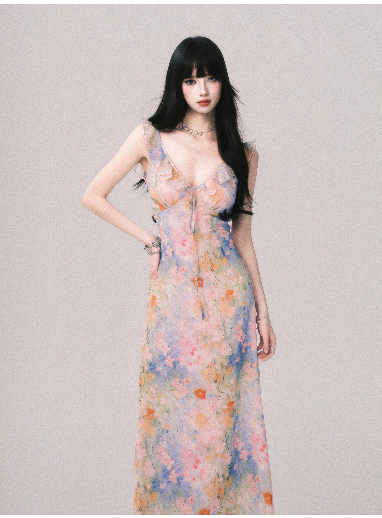 Side three-quarter view of pastel watercolor floral maxi slip dress with ruffled neckline trim and spaghetti straps