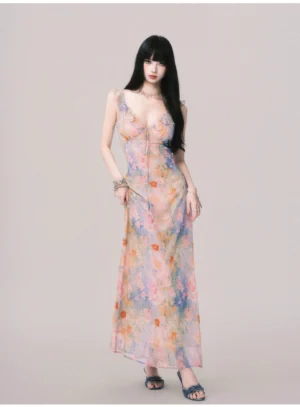 Women's pastel floral maxi slip dress with deep V neckline and flowing floor-length skirt in three-quarter front view