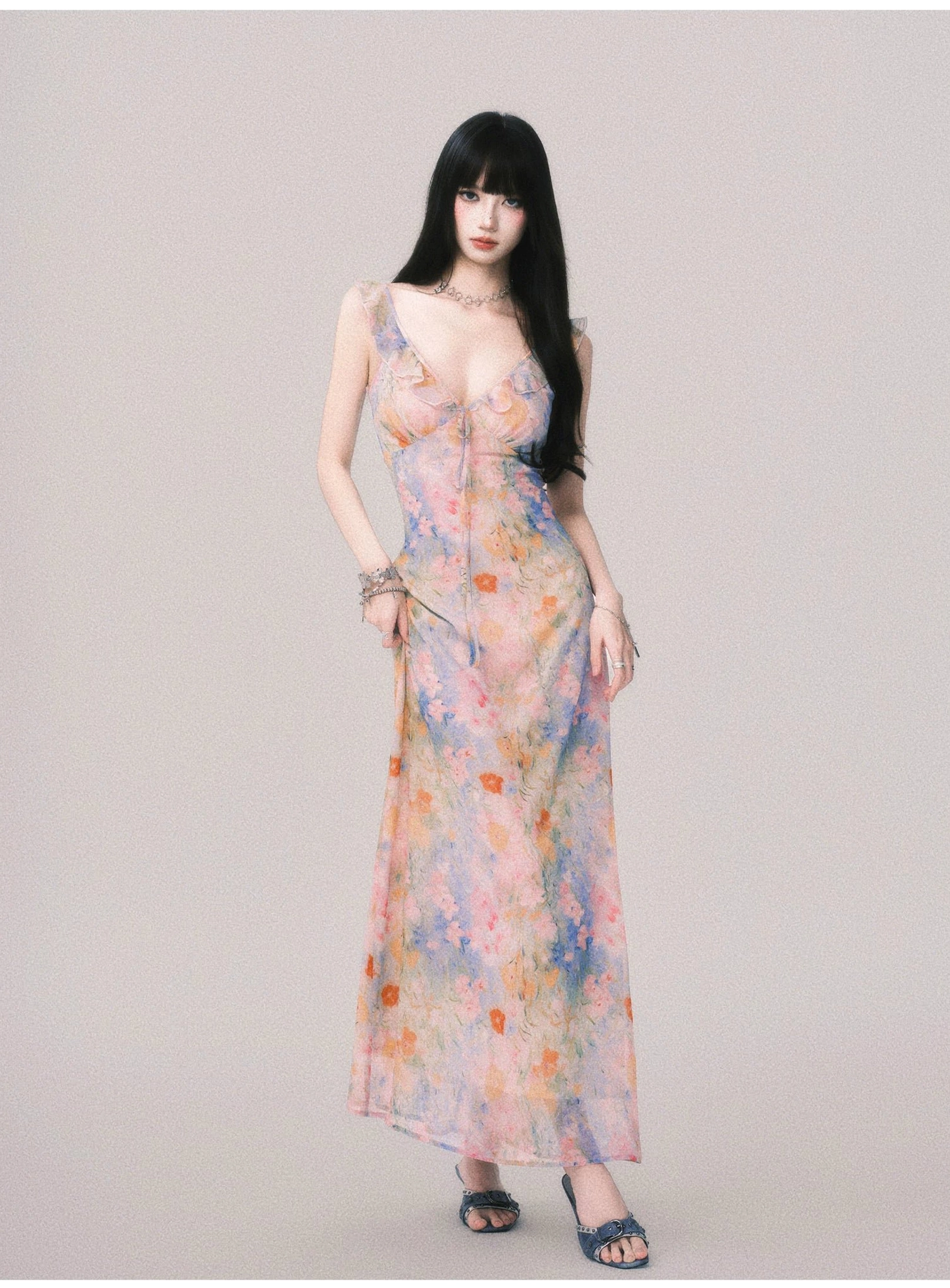 Women's pastel floral maxi slip dress with deep V neckline and flowing floor-length skirt in three-quarter front view