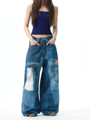 Women patchwork wide leg denim jeans shown from the front with hands on hips, multi-panel indigo denim design, loose oversized fit, and leather waist patch