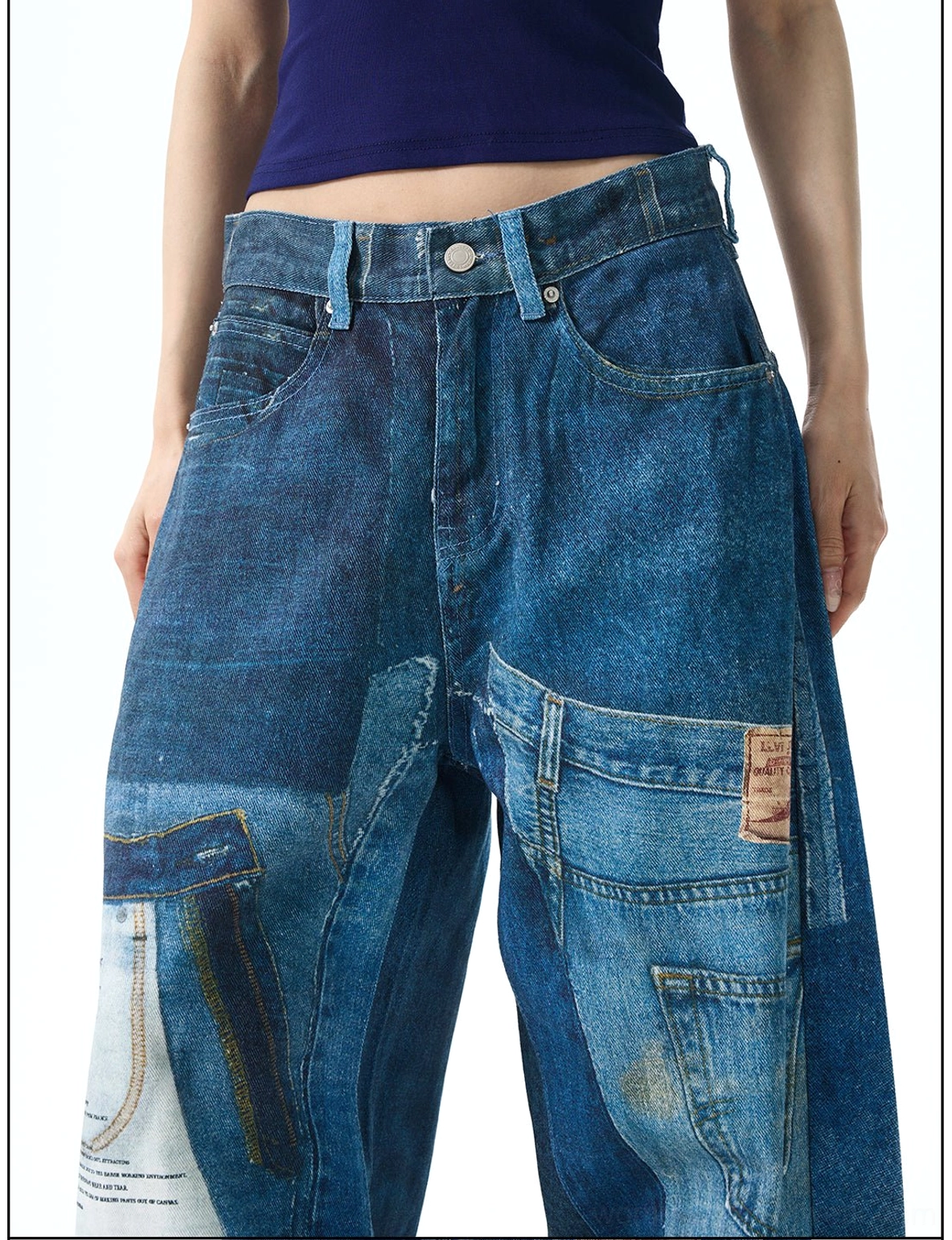 Close-up of patchwork wide leg jeans waistband and upper legs with button fly, cargo-inspired patched pockets, and contrasting indigo denim panels