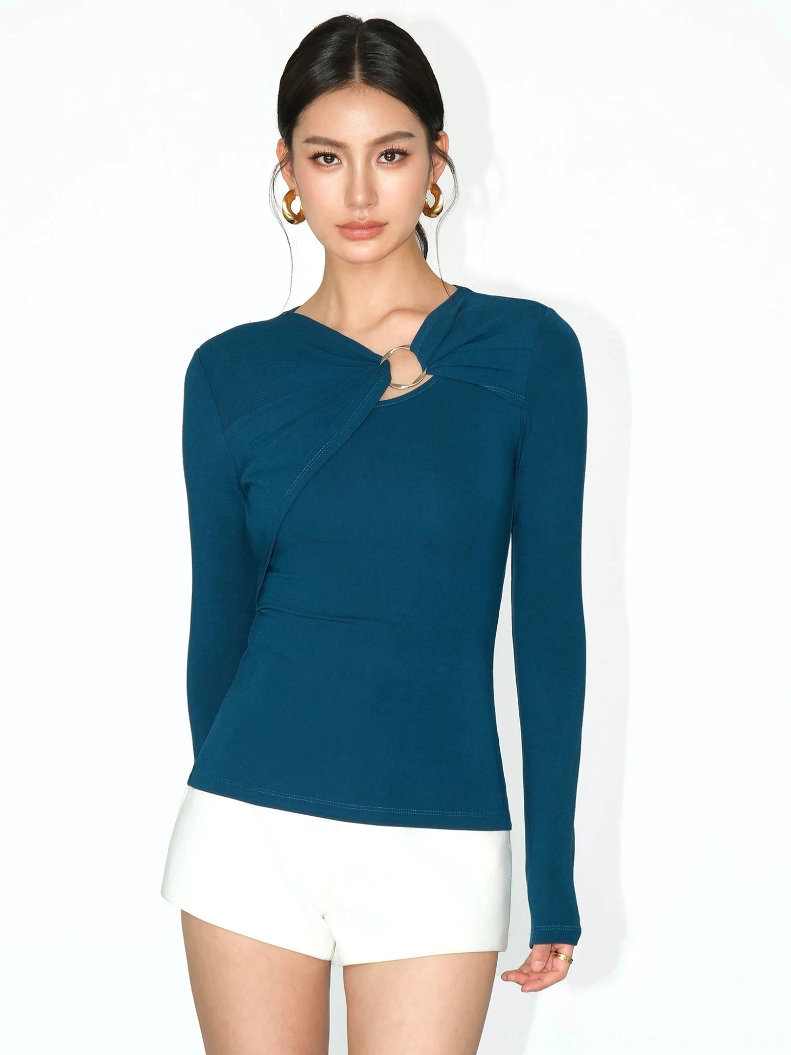 Peacock blue slim fit ring cutout long sleeve top styled with white mini shorts in Y2K fashion