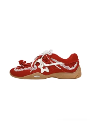 Red pearl lace ballet runner sneakers with white lace bows, star embellishments, layered lacing, and brown gum rubber sole side view