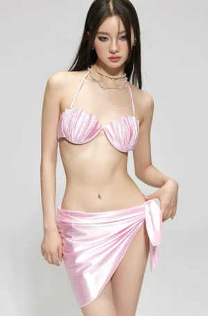 Pink pearl shell bikini set with rhinestone trimmed halter top and satin tie wrap mini skirt