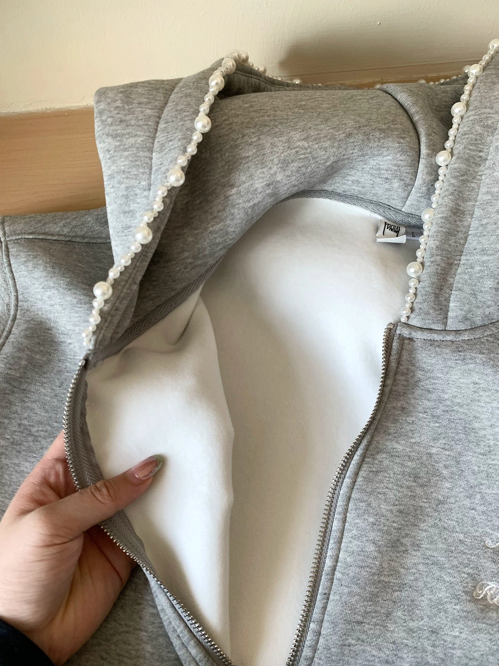 Heather gray pearl trim oversized zip-up hoodie close-up showing plush brushed fleece lining and hood structure