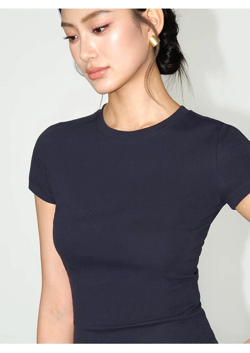 pearl white crew neck fitted t-shirt styled with high waisted trousers minimalist contemporary look