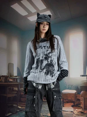 Female model wearing gray phantom stripe layered knit streetwear long sleeve tee with distressed black graphic front