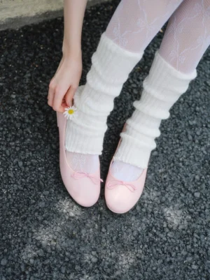 Pink bow ballet flats styled with white ruffled lace socks and a delicate daisy detail
