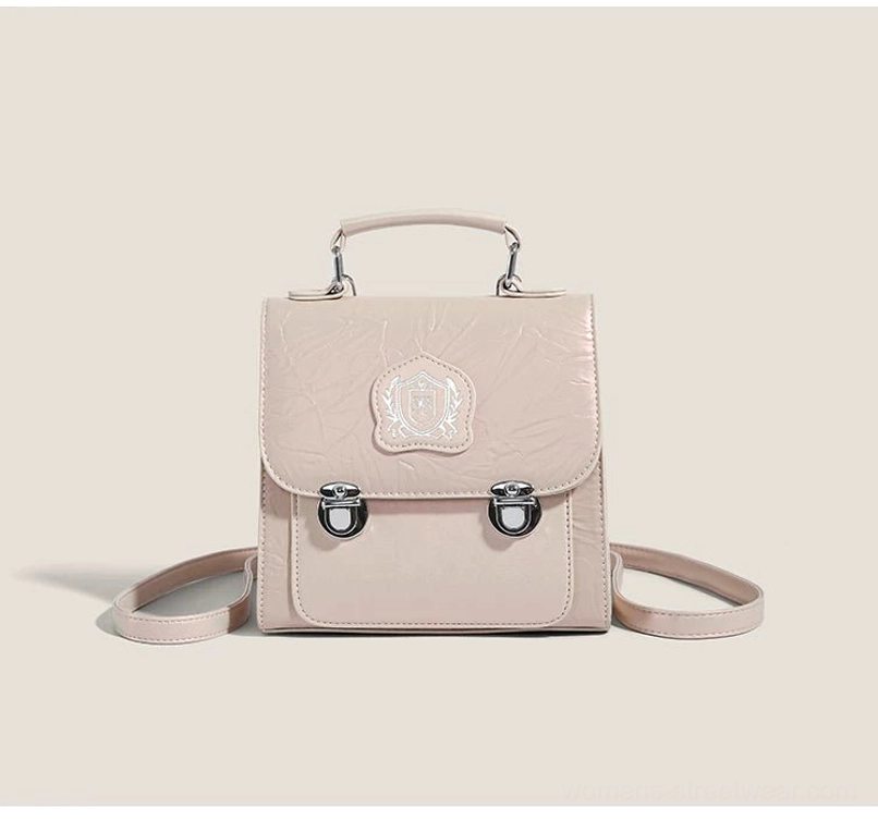 Pink crinkle PU crested mini satchel crossbody bag with silver buckles, structured top handle, and detachable shoulder strap
