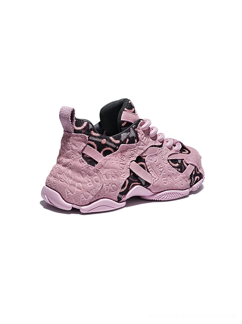 Rear side view of pink embroidered chunky dad sneakers showing black inner lining, textured upper patterns and thick rubber outsole