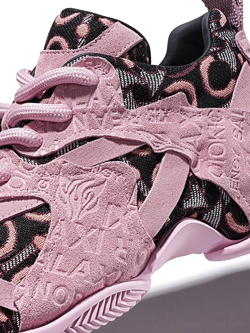 Close-up of pink embroidered chunky dad sneaker upper showing suede-textured overlays, tonal monogram embroidery, patterned mesh and pink lace loops