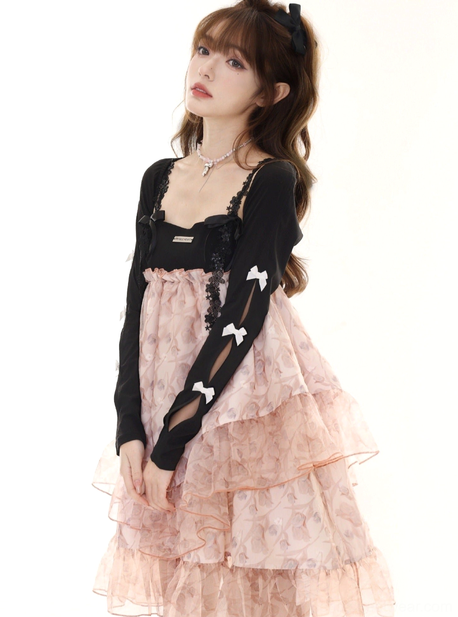 Pink floral Lolita slip dress with bow details and black cardigan sleeves in a romantic outfit