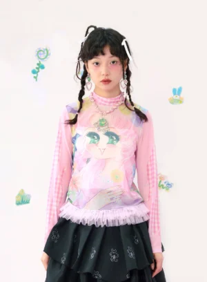 Front close-up of pink gingham cartoon graphic long sleeve top with mock neck and pink tulle ruffle hem