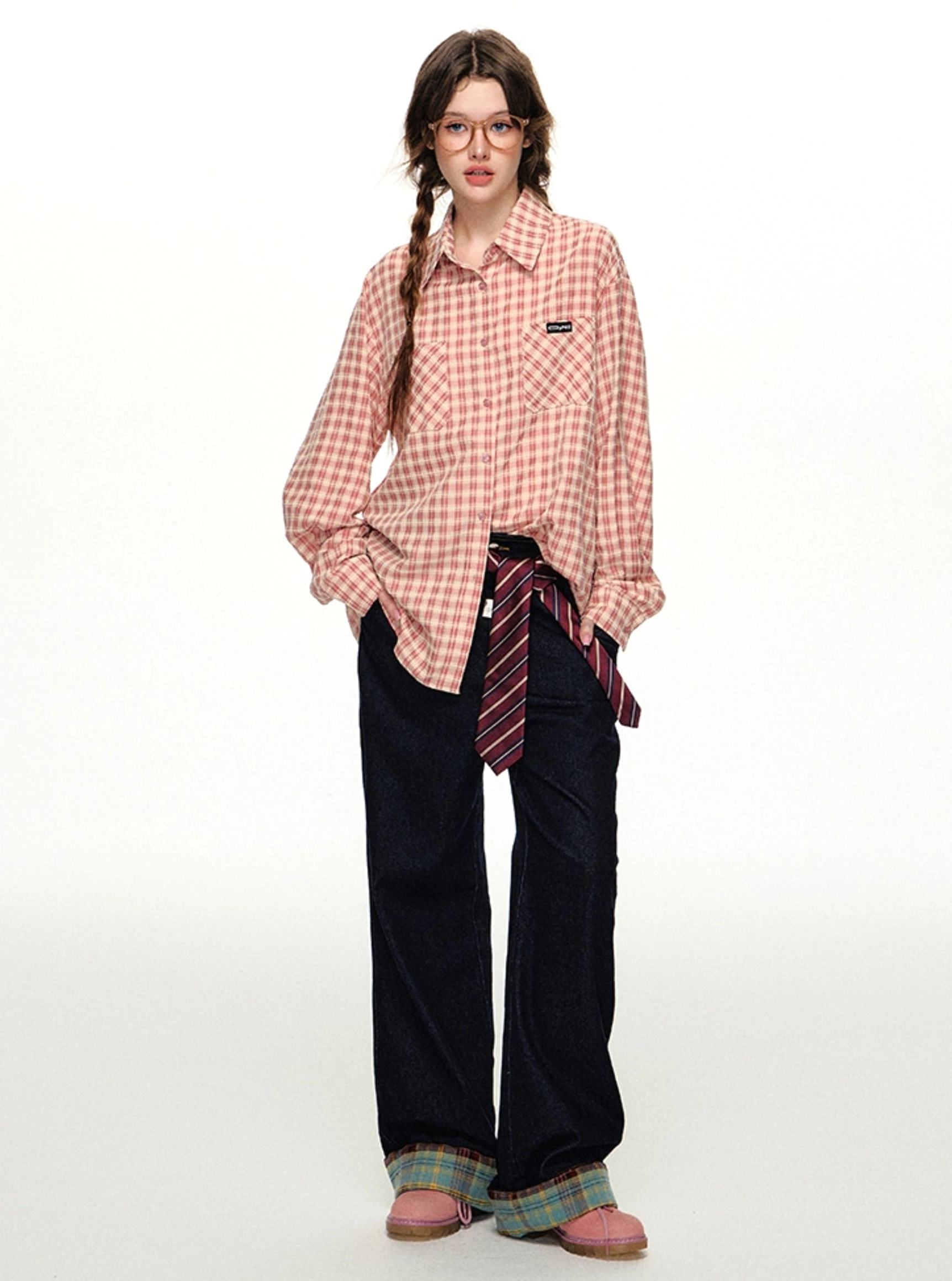 Pink gingham long-sleeve streetwear shirt paired with dark wide-leg pants and a striped waist tie in a casual Korean look