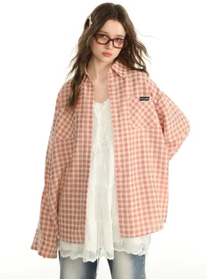 Pink gingham oversized button-up shirt styled with a white lace dress and frayed wide-leg jeans in a retro Korean streetwear outfit
