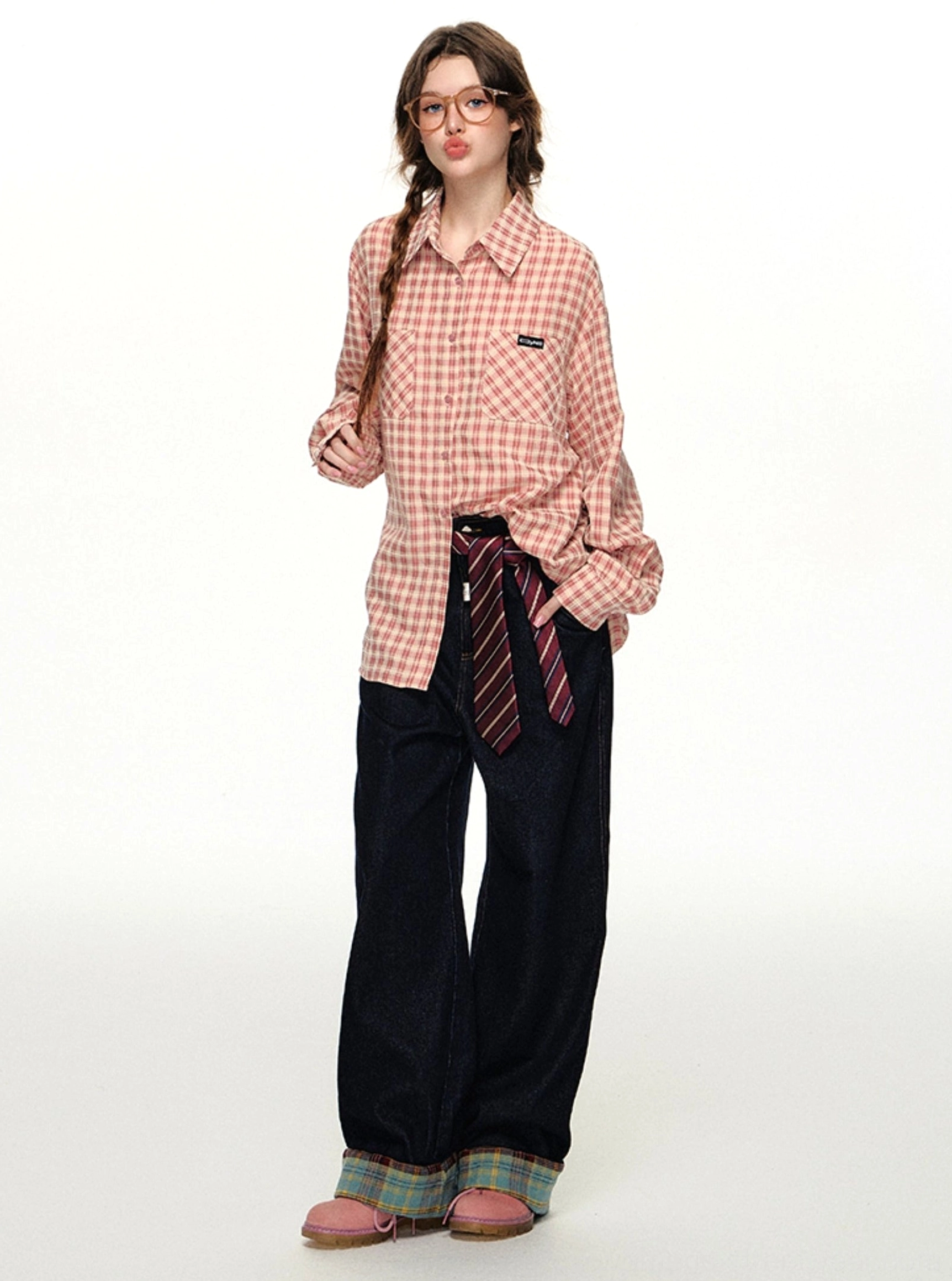 Full-body outfit featuring a pink gingham oversized shirt, dark wide-leg trousers, striped waist tie, and pink loafers