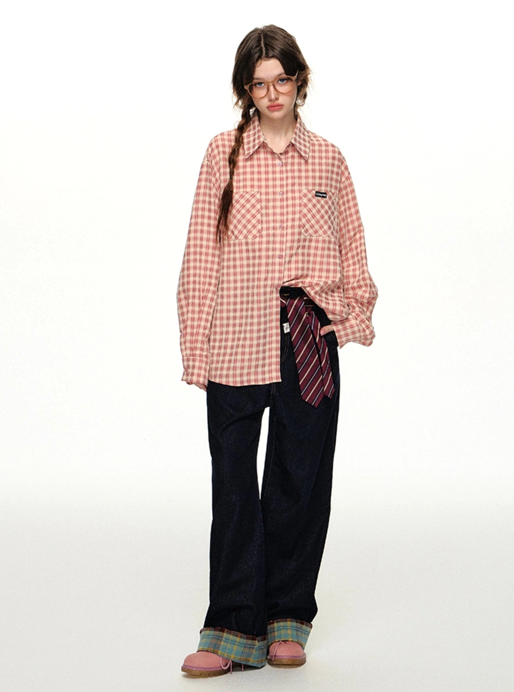 Pink gingham retro shirt with a loose boyfriend silhouette styled with dark trousers and rolled plaid cuffs