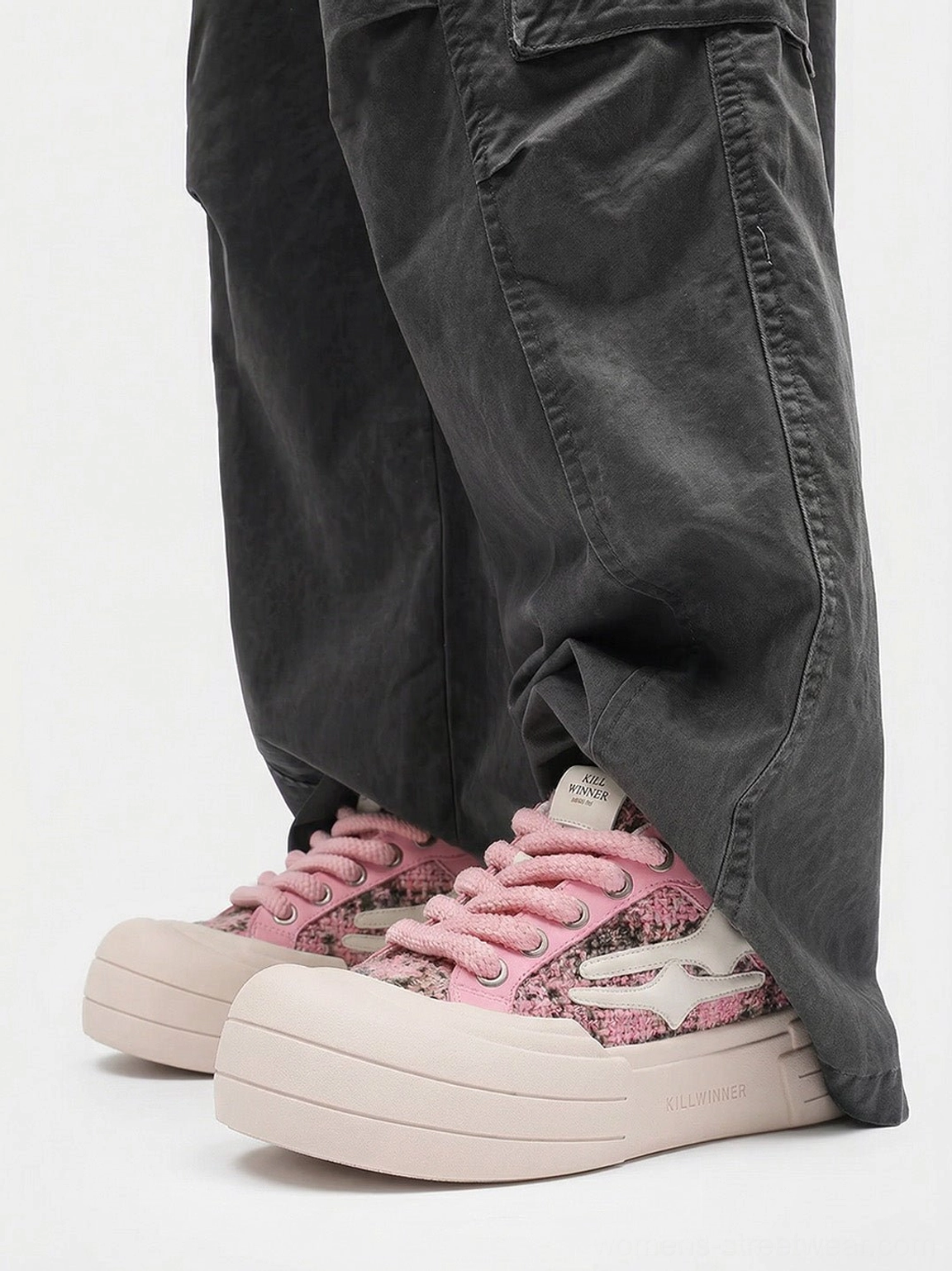 Pink glitter platform sneakers styled with dark gray cuffed cargo pants in a casual Seoul-inspired streetwear outfit