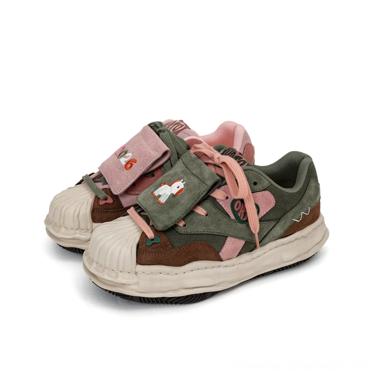 Overhead display of pink dark green and brown color block patch sneakers with mixed suede-style panels and cream rubber soles