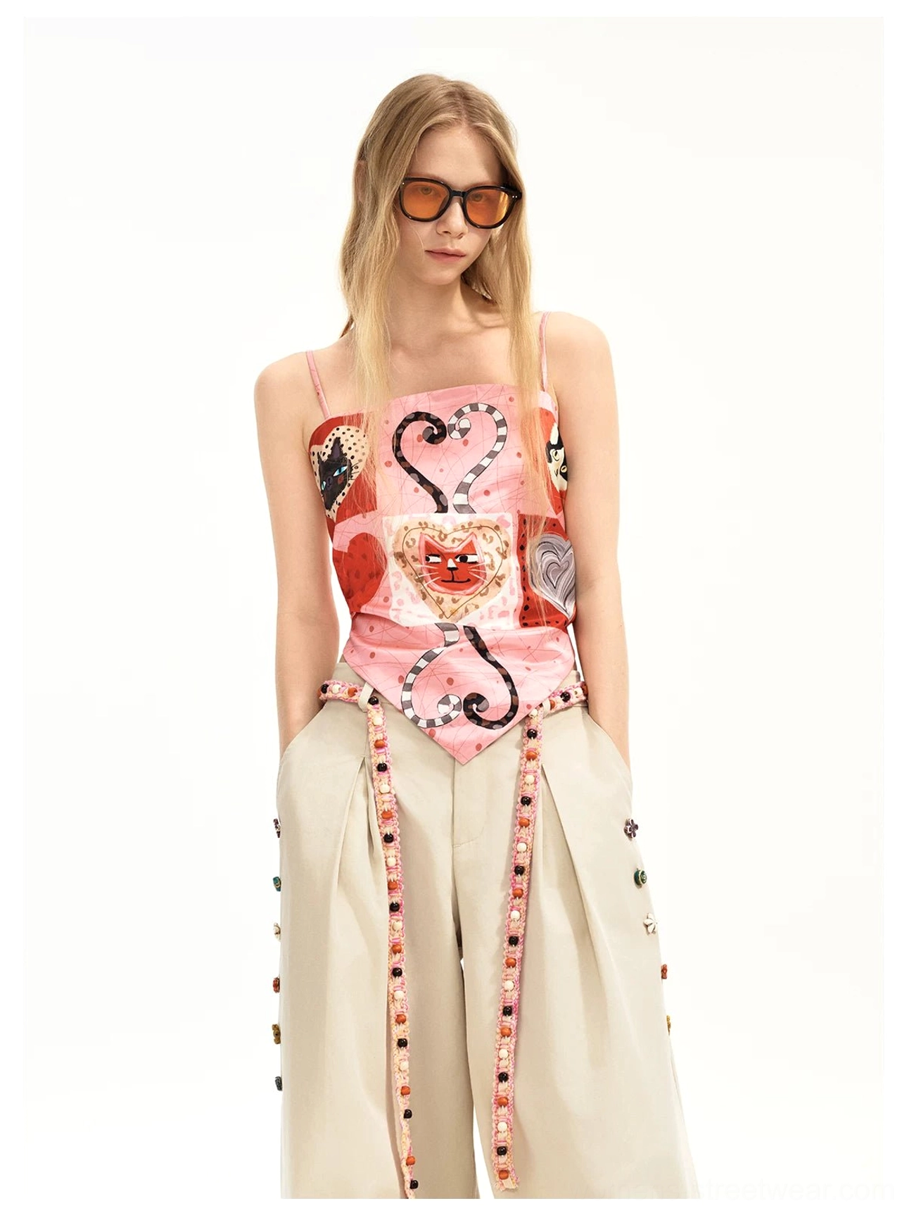 Y2K pink kitten heart patchwork cami top styled with beige wide leg trousers