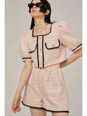 Pink lace trim tweed blouse and high-waist shorts two-piece set worn by model in studio