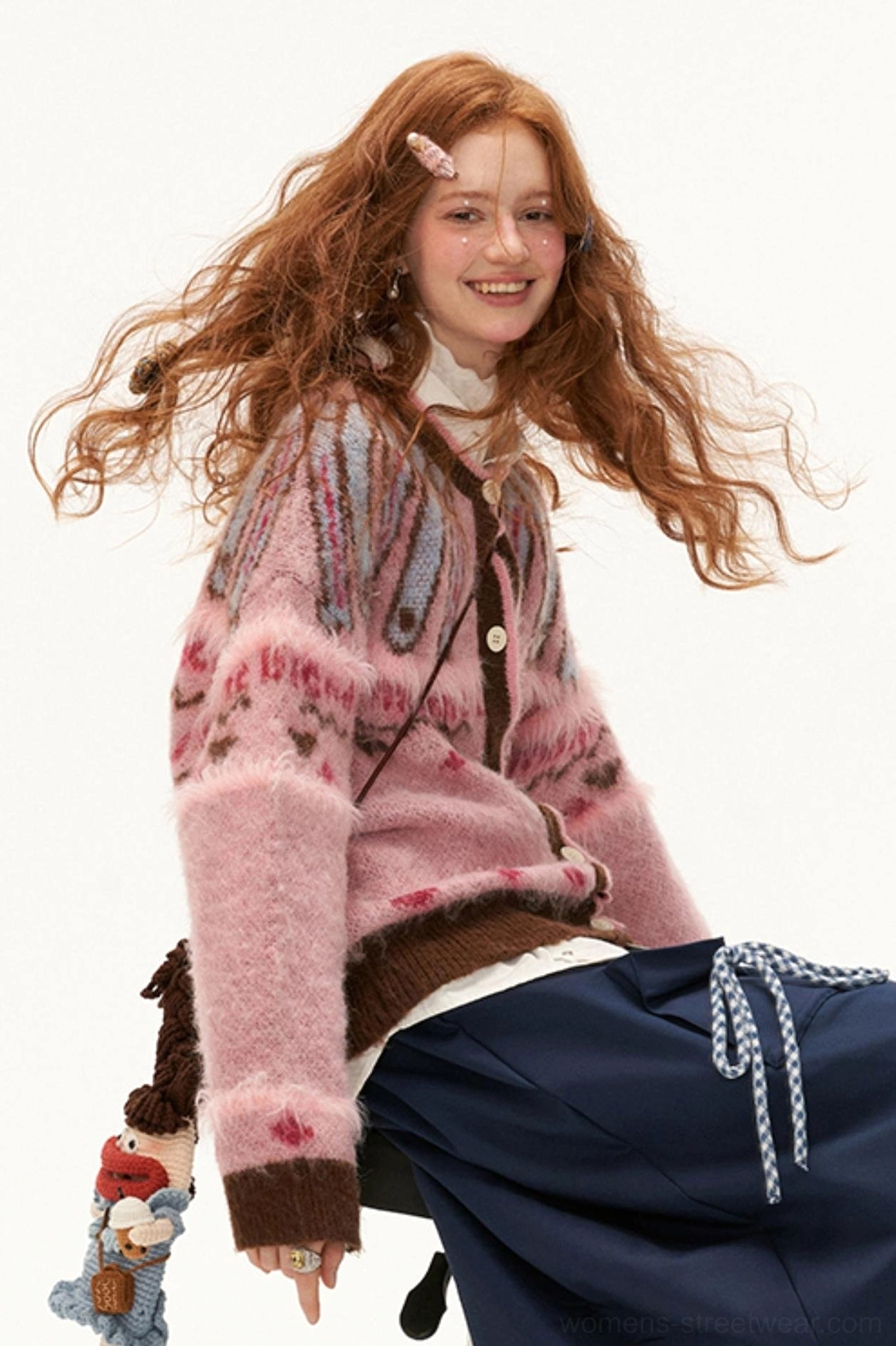 Back three-quarter view of pink mohair Fair Isle heart knit cardigan showing all-over jacquard pattern