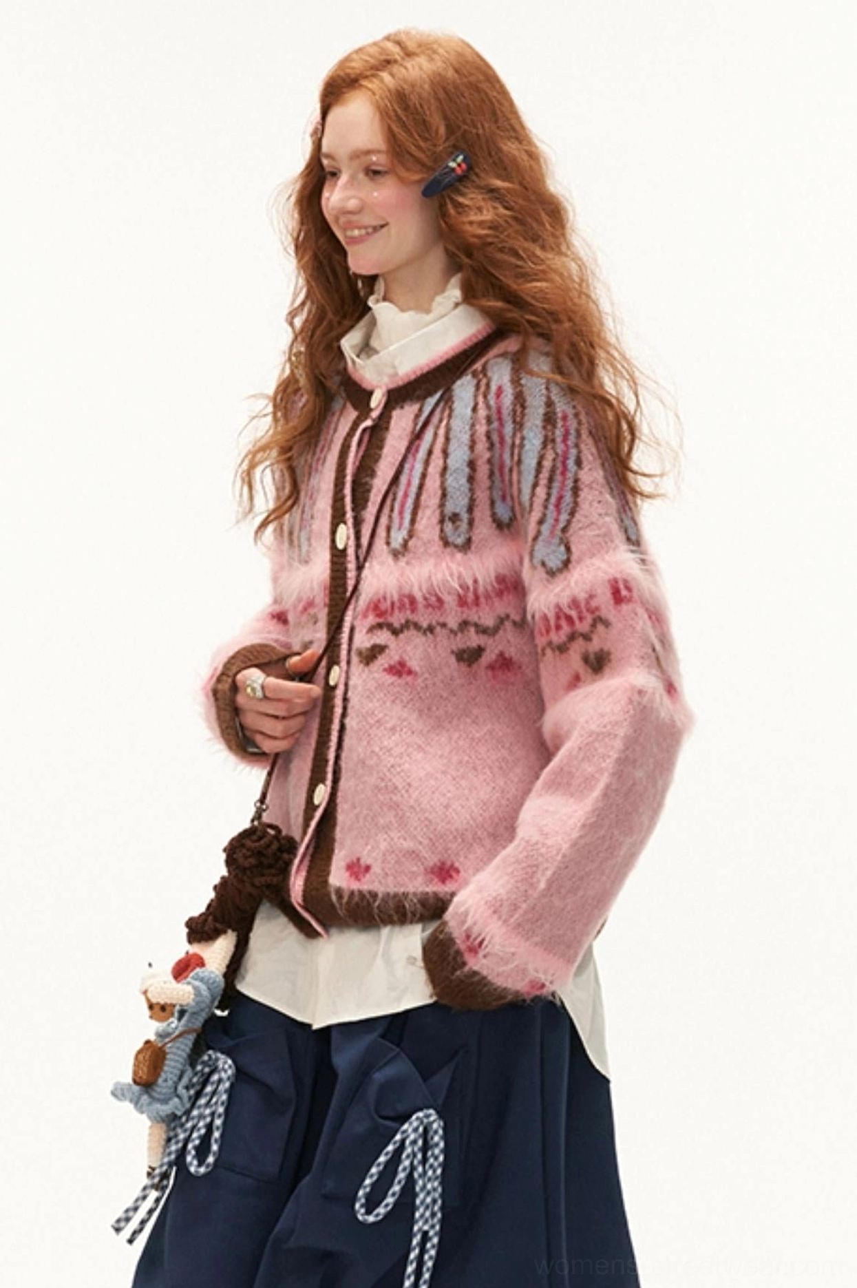 Side view of pink mohair Fair Isle streetwear cardigan with geometric knit motifs and brown ribbed hem