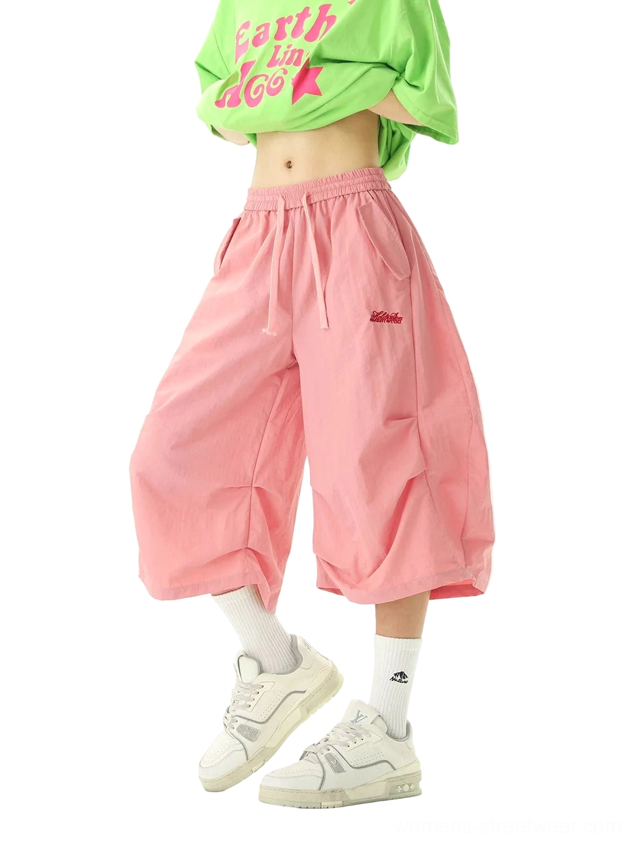 Pink oversized balloon jogger shorts with a relaxed lantern silhouette, adjustable drawstring waist, matte nylon fabric, and embroidered detail styled for Korean streetwear