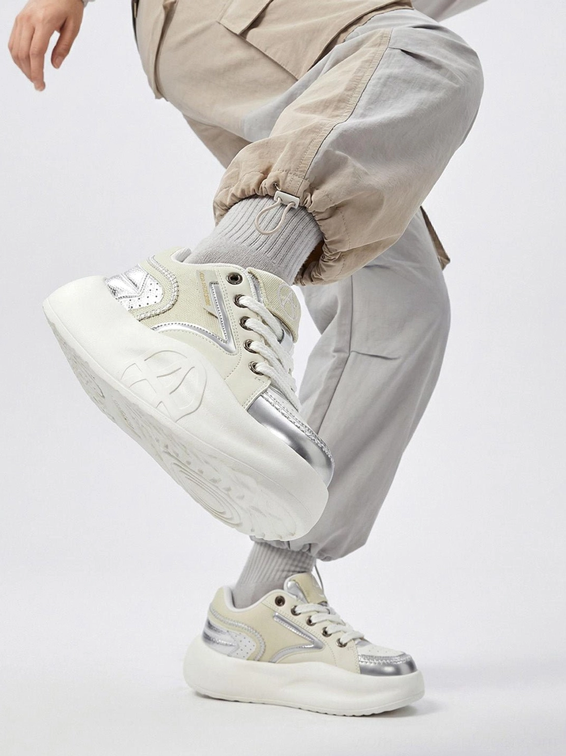 Pink pastel platform runner sneakers with metallic overlays breathable mesh and bold Y2K-inspired athletic silhouette