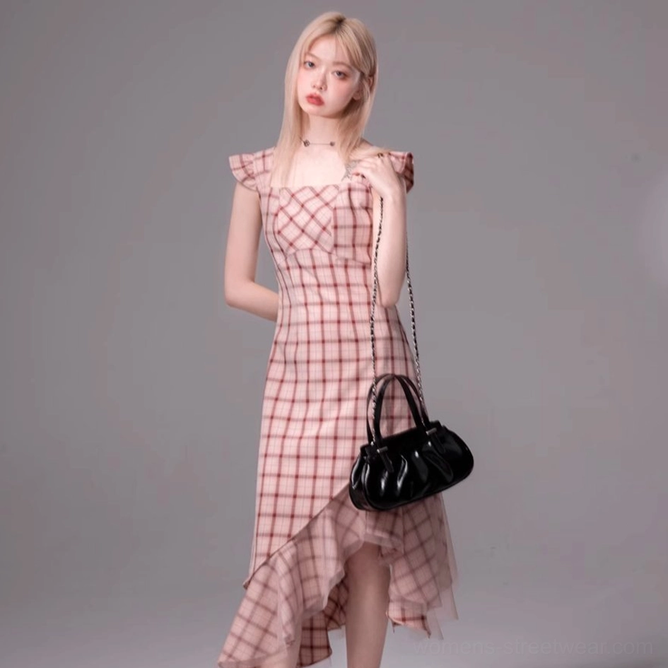Back-side view of a pink plaid asymmetric midi dress with fitted waist and flowing ruffled high-low hem