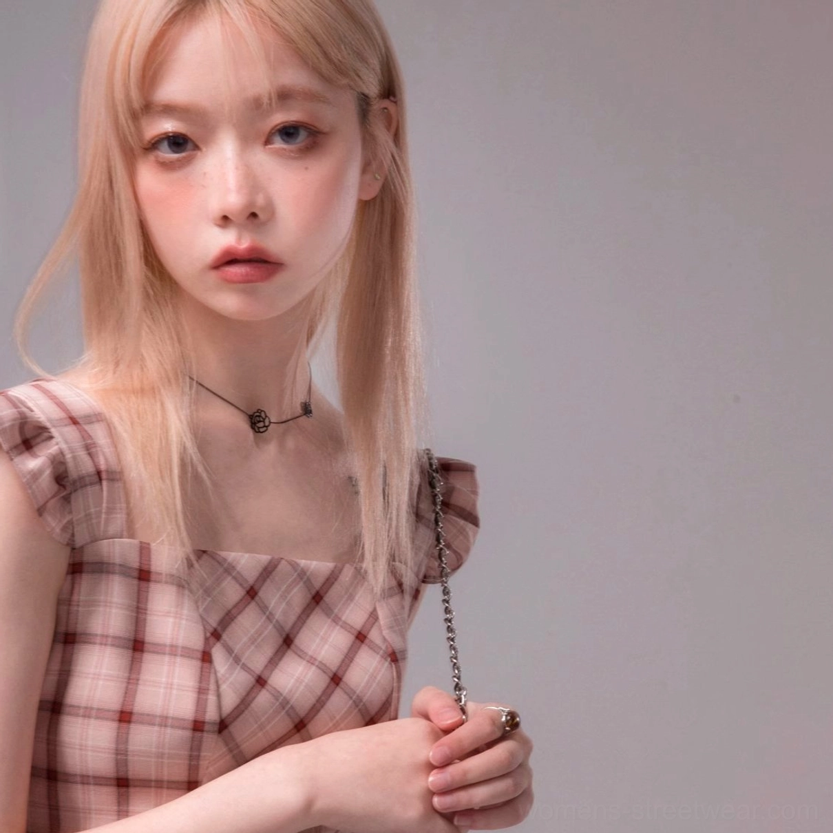 Close-up of pink plaid streetwear midi dress showing sweetheart neckline and layered flutter sleeve details