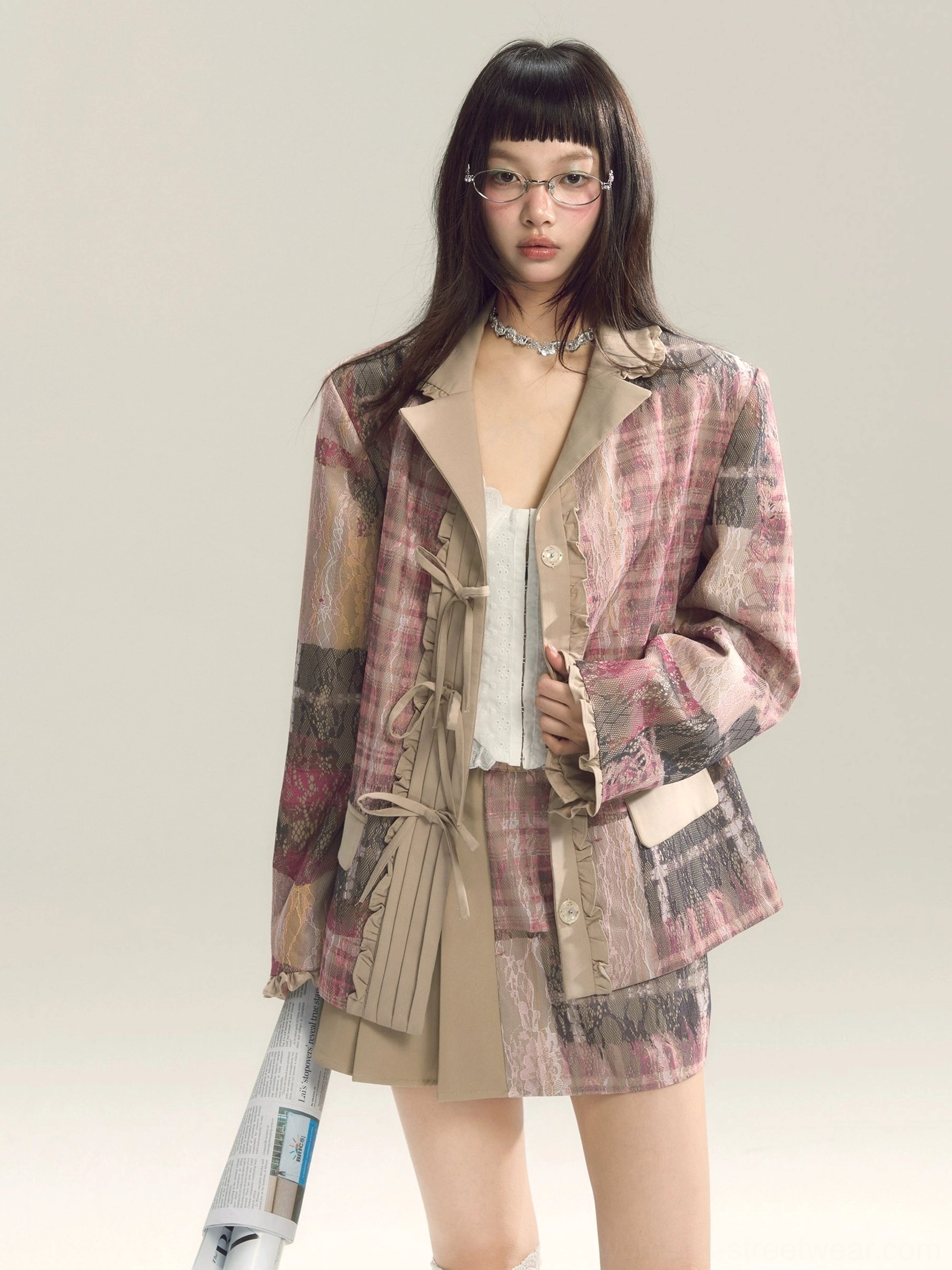 Pink plaid textured blazer and pleated mini skirt outfit with relaxed tailoring and romantic preppy streetwear details