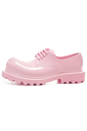 Side profile of glossy pink platform derby shoe with rounded distressed toe and deep ridged lug outsole