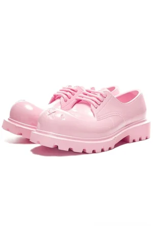 Pink glossy platform derby shoes with chunky lug sole shown in three quarter front view on a white studio background