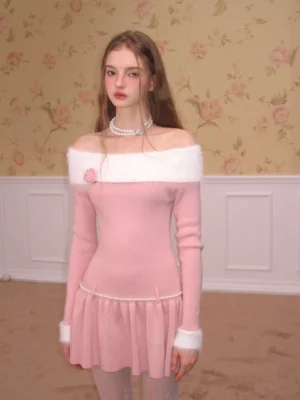 Pink ribbed off-shoulder knit skater dress with long sleeves, white fuzzy trim, pearl waist accent, and flared ruffle mini skirt
