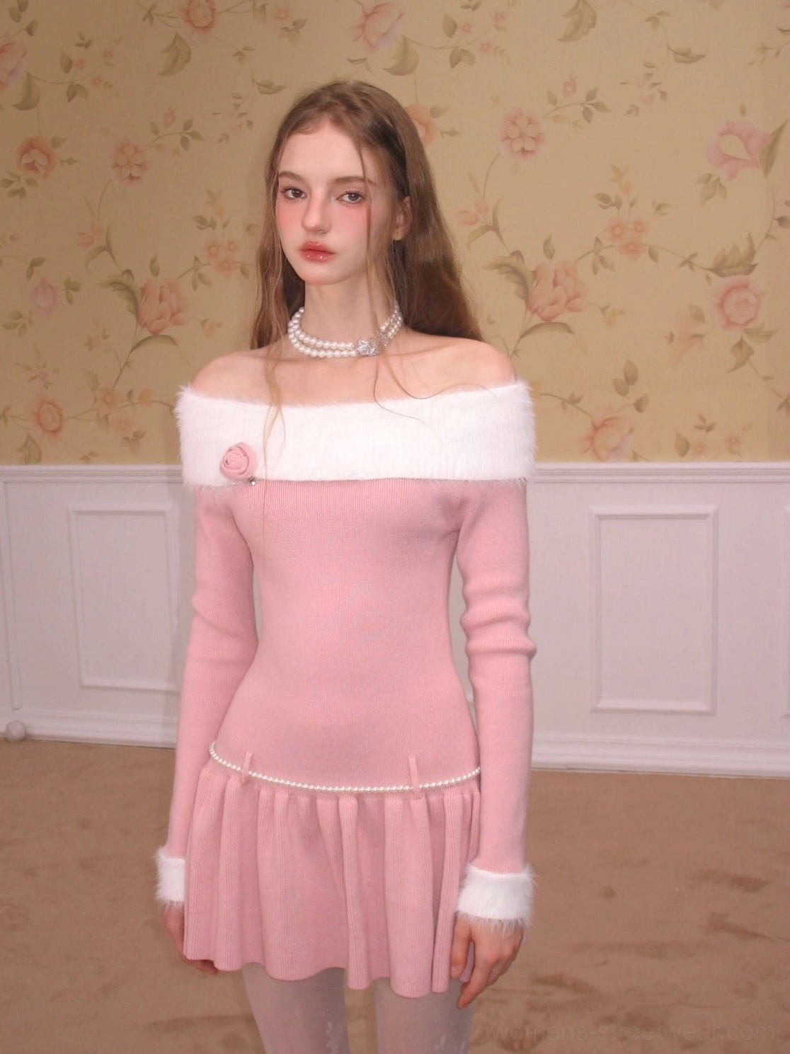 Pink ribbed off-shoulder knit skater dress with long sleeves, white fuzzy trim, pearl waist accent, and flared ruffle mini skirt