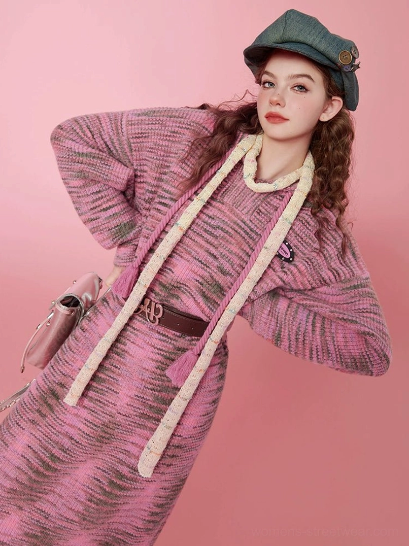 Three-quarter view of a pink space-dyed hooded knit midi sweater dress with cream drawstrings and relaxed Korean streetwear styling