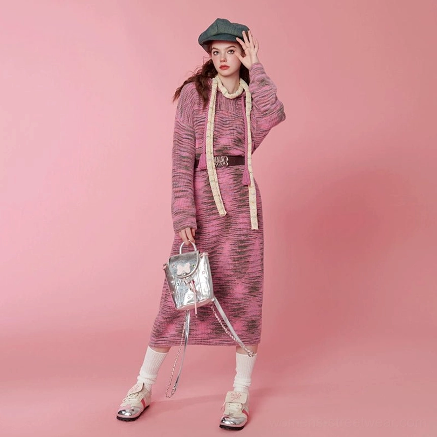 Three-quarter front view of a pink space-dyed hooded knit midi sweater dress with cream drawstrings and straight midi hem